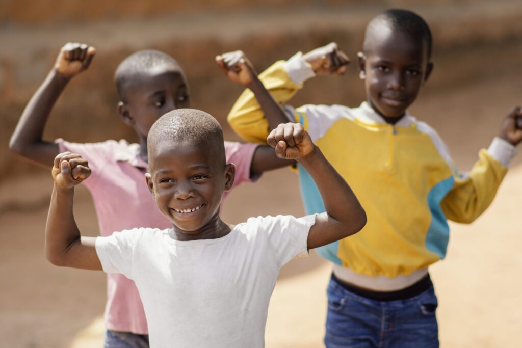 medium shot smiley african boys scaled.jpg